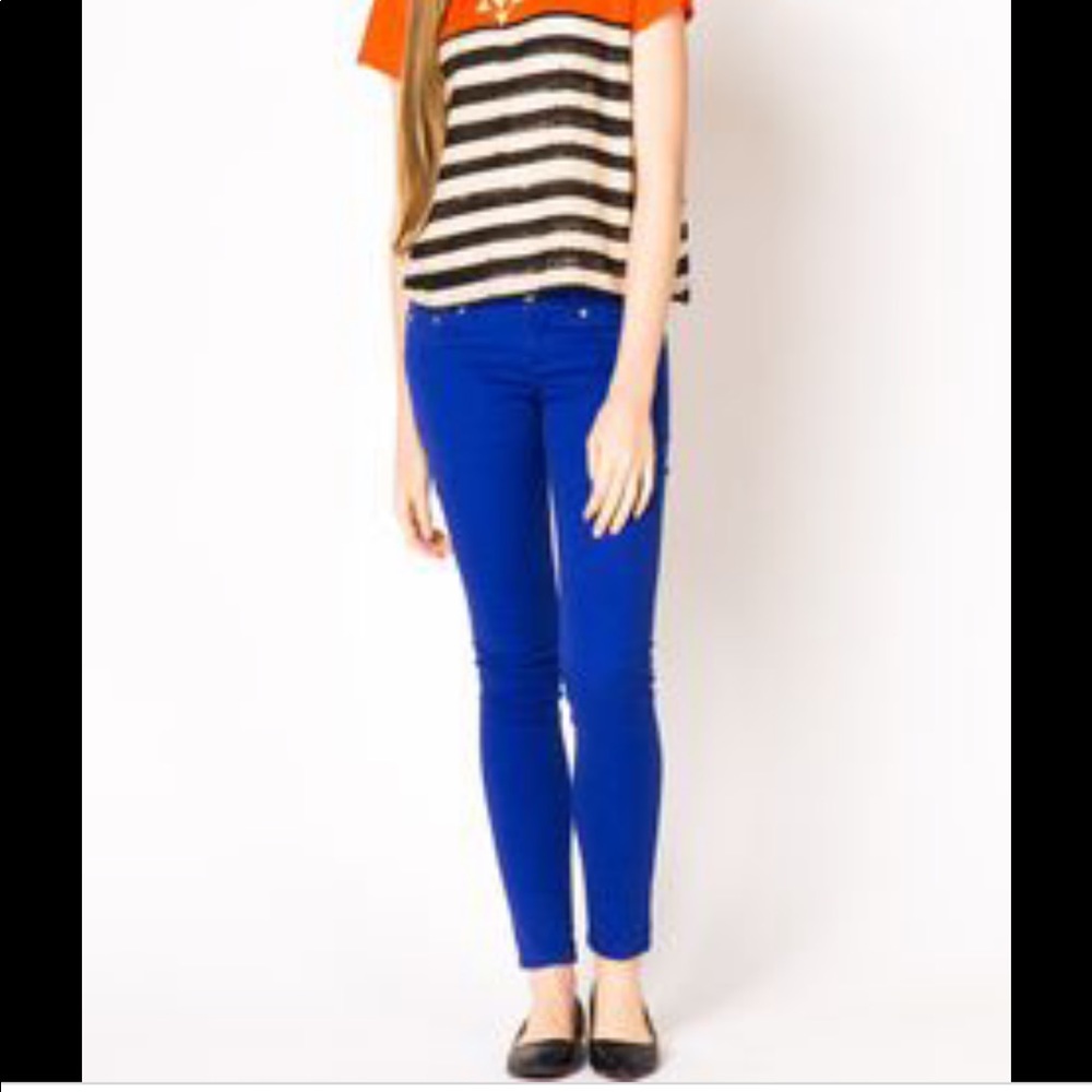 Neon blue skinny jeans with distressed accents